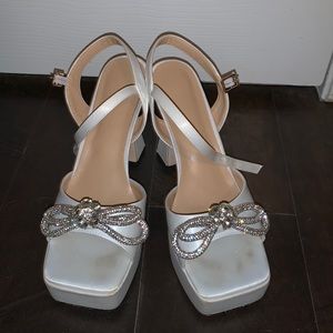 White satin heels with crystal bow